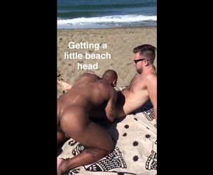 Enormous ebony stud blowing man's beef whistle on the beach
