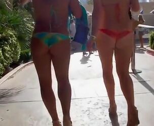 2 beauties walk around the town in exposing bathing suits